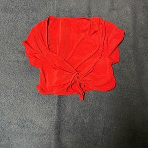 Red short sleeve cropped top tie up front. Size Medium